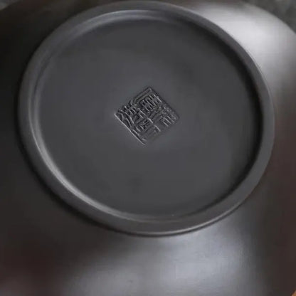Close-up of the finely finished zisha teapot base with an impressed maker's stamp