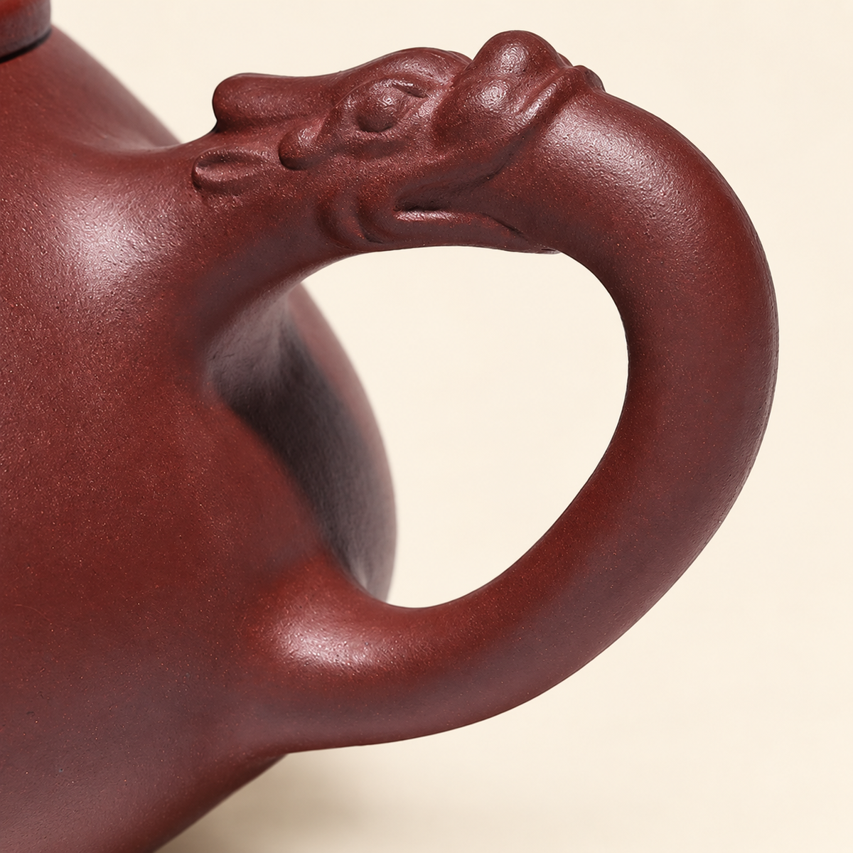 Close-up of the sculpted dragon detail forming the Yixing teapot handle