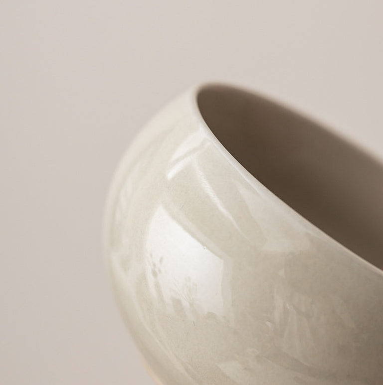 Close-up of the softly variegated gray ceramic glaze and rounded cup rim
