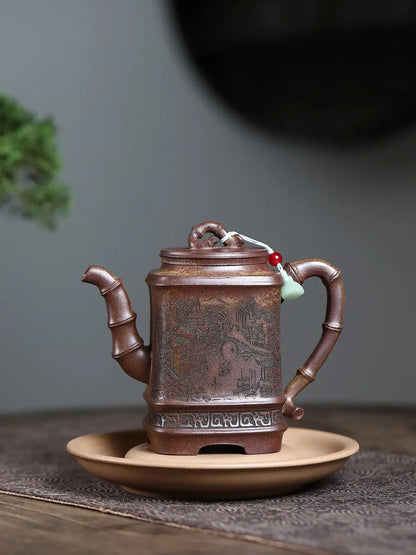 Square Jiangnan zisha teapot displayed on a tea plate in a quiet tabletop setting