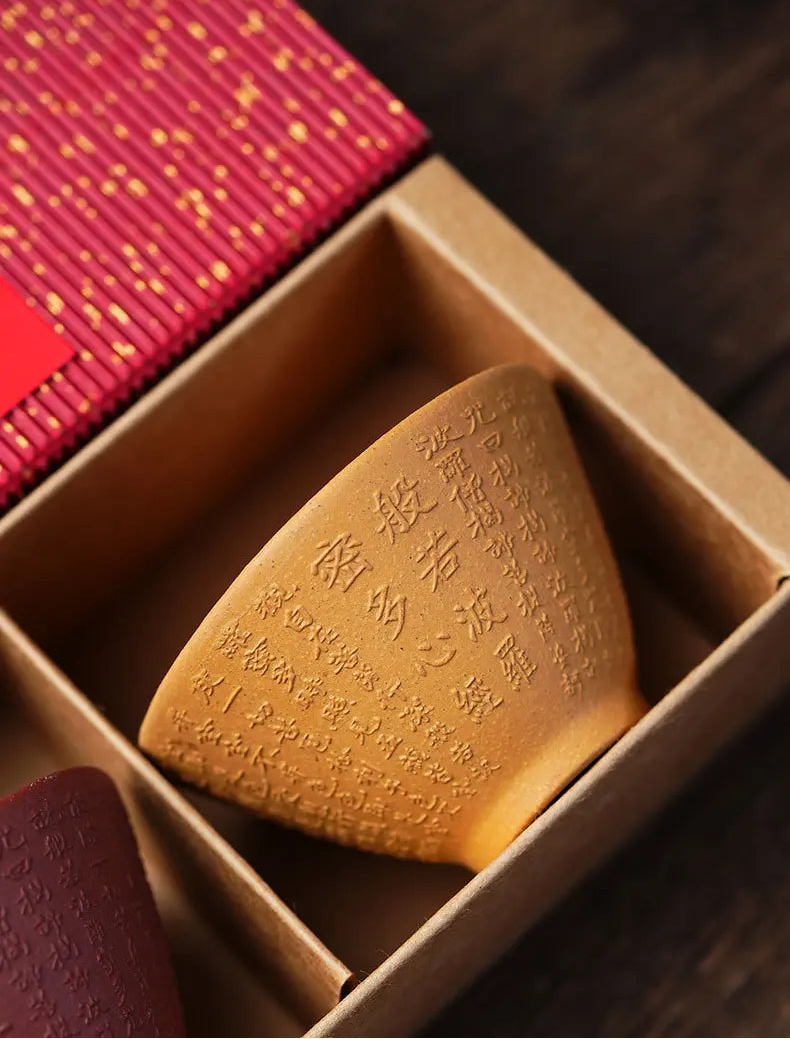 Ochre Heart Sutra zisha tea cup inside the divided red gift box
