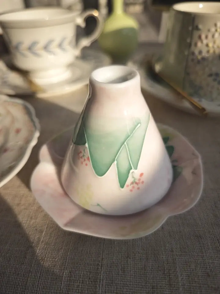 Reverse and foot detail of the blush-green hand-painted landscape ceramic teacup