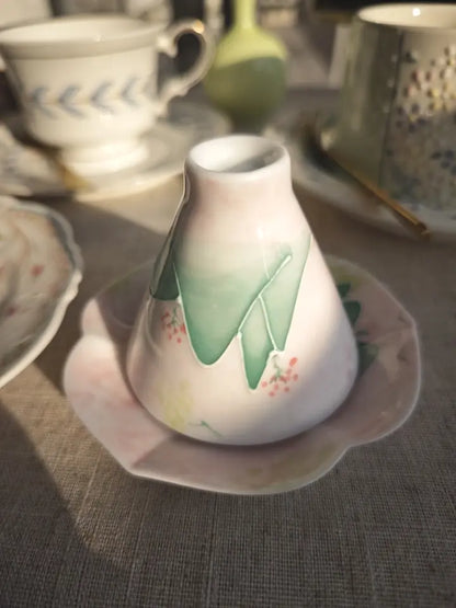Reverse and foot detail of the blush-green hand-painted landscape ceramic teacup
