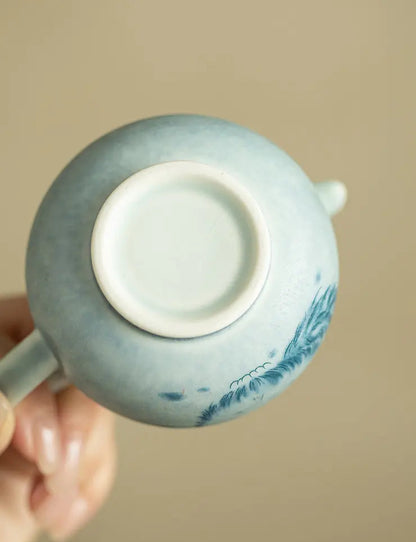 Bottom view of the cat ceramic teapot showing its circular foot-ring base
