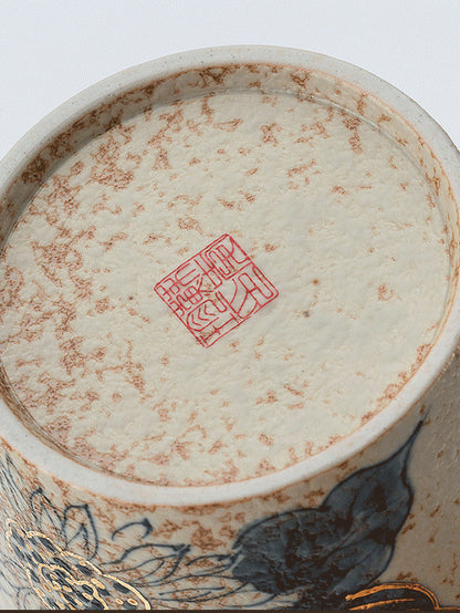 Close-up of the stamped base and reactive glaze on the ceramic coffee cup
