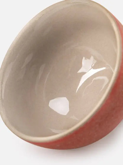 Close-up of the smooth glazed interior of the coral ceramic teacup
