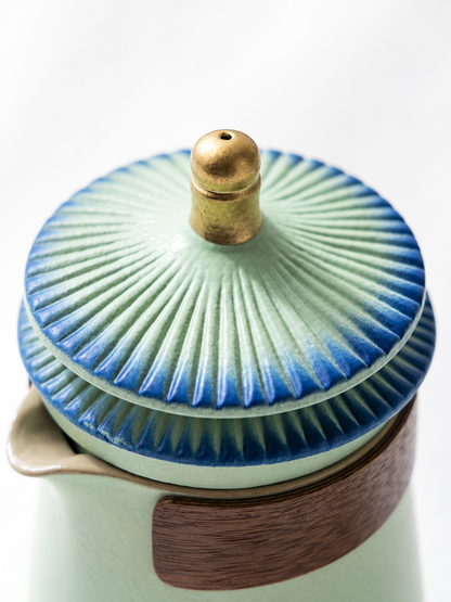 Layered palace-eaves ceramic lid with blue-edged ridges and gold-colored knob
