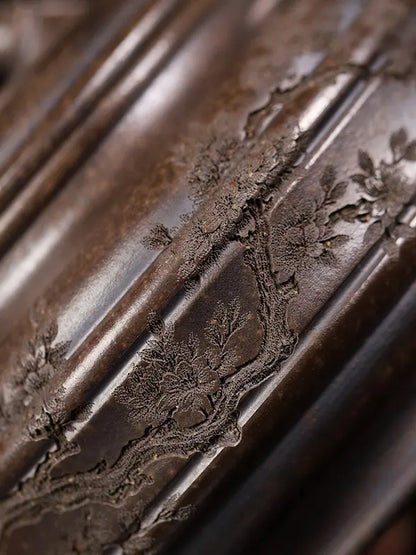 Raised floral-branch relief on the body of a bronze-brown bamboo drum zisha teapot