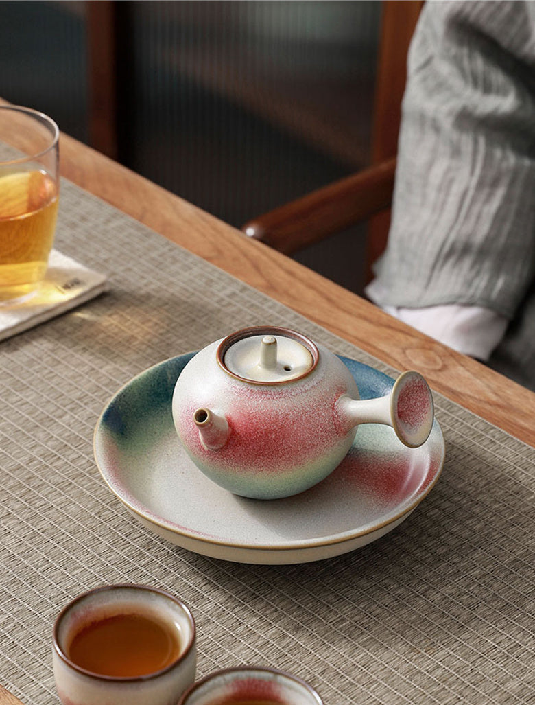 Side-handle rainbow glaze ceramic teapot in a tea table setting