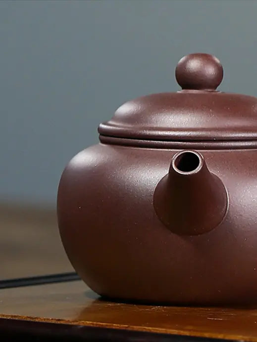 Close-up of the straight spout and fine brown zisha clay surface