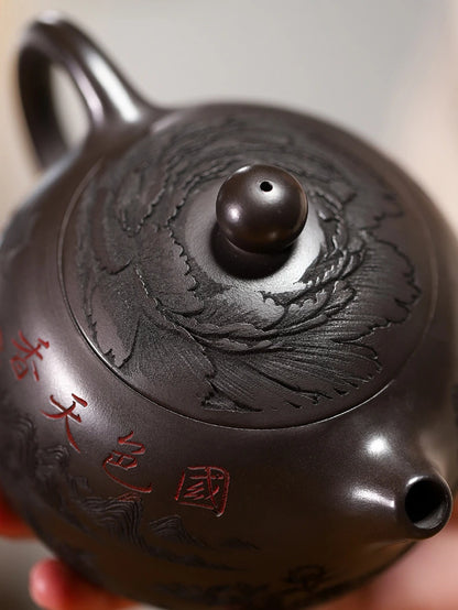 Close-up of the teapot lid carving, short spout, and red Chinese inscription