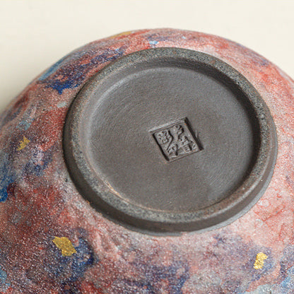Close-up of the teapot base with its stamp and mottled glaze
