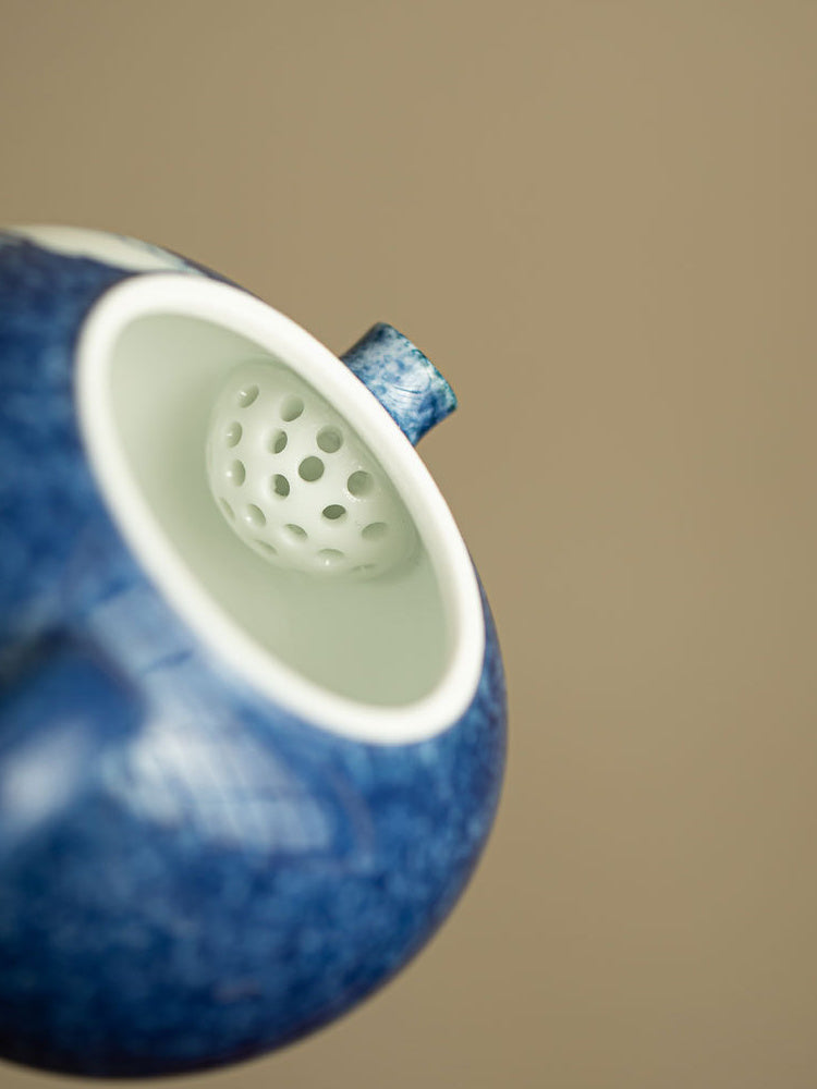 Close-up of the built-in multi-hole filter inside the ceramic teapot
