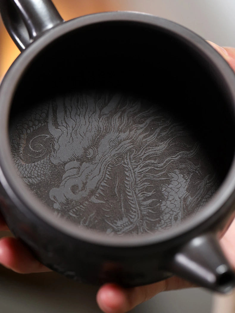 Underside of the Yixing zisha teapot with detailed crane and peony carving