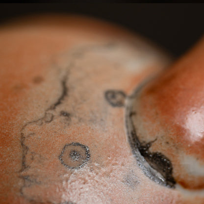 Close-up of orange and gray kiln-glaze variation on the ceramic teapot