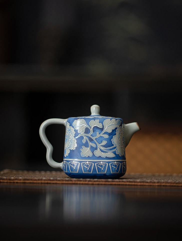 Rear view of the blue crackle glaze teapot with white foliage decoration
