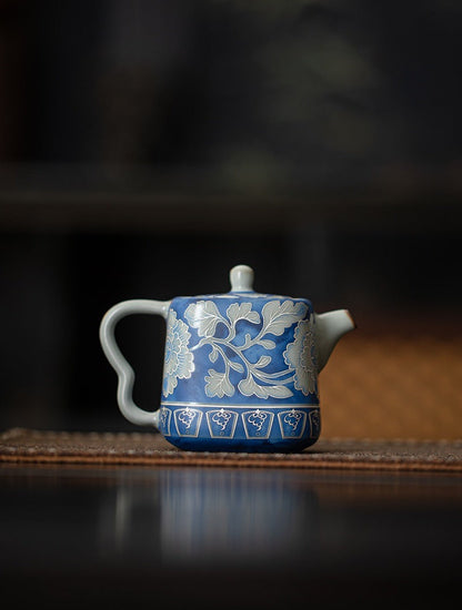 Rear view of the blue crackle glaze teapot with white foliage decoration
