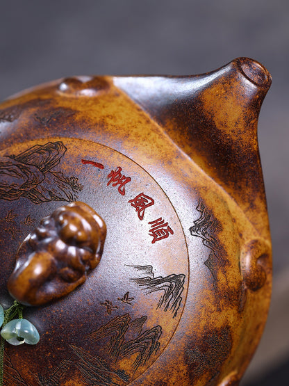 Close-up of the short teapot spout, lid, and red Chinese inscription on the wood-fired zisha surface
