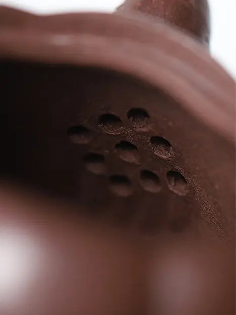 Close-up of the nine-hole outlet inside a handcrafted zisha teapot