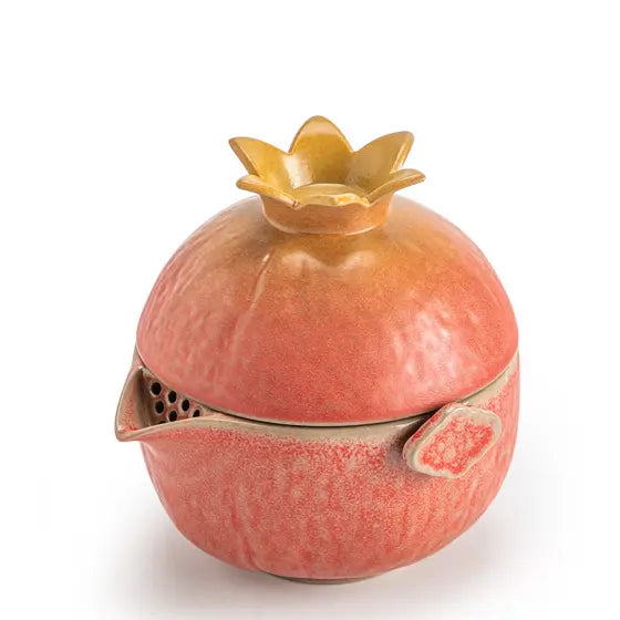 Closed pomegranate-shaped ceramic travel tea set with crown and filter spout
