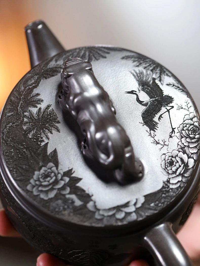 Hidden dragon carving visible inside the handmade Yixing zisha teapot