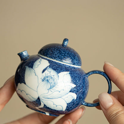 Close-up of the hand-painted white lotus and deep blue mottled glaze

