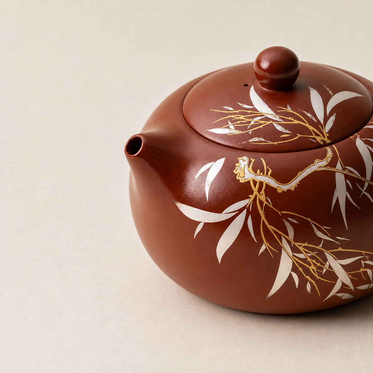 Close-up of Yixing zisha teapot showing bamboo and golden cicada detailing