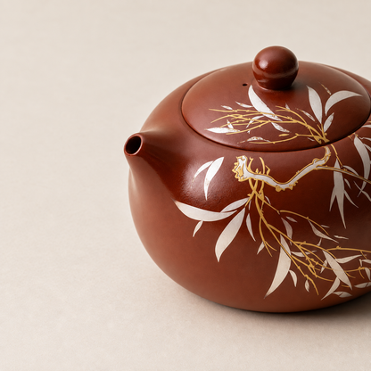 Close-up of Yixing zisha teapot showing bamboo and golden cicada detailing