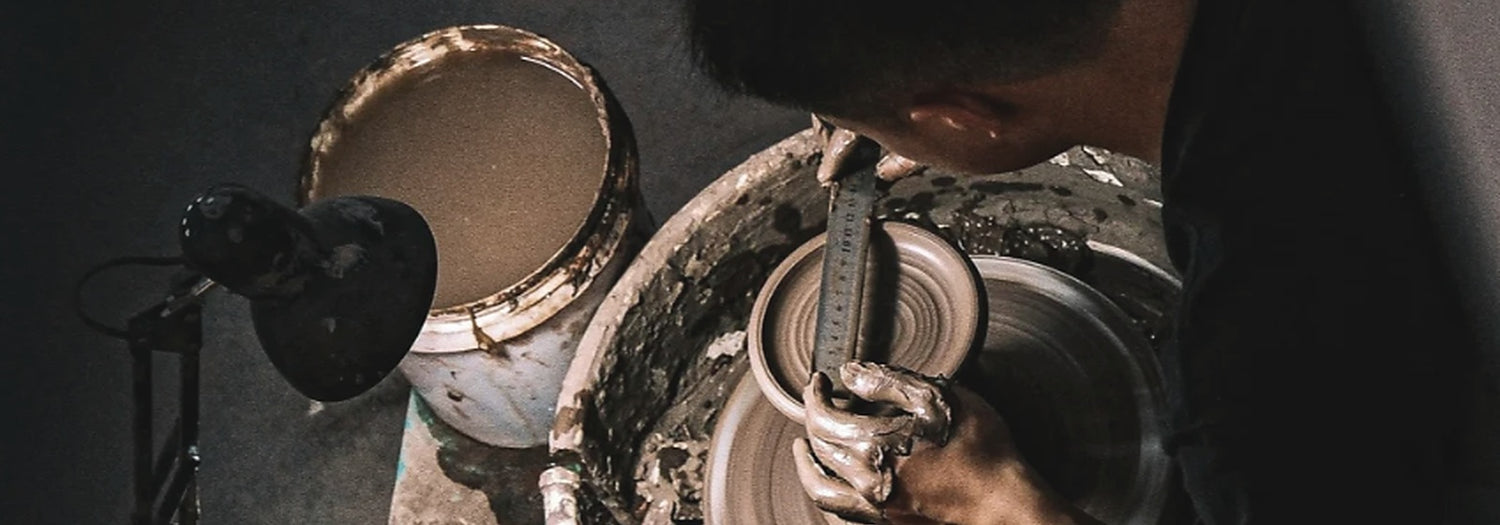 Jingdezhen artisan shaping clay in a porcelain studio